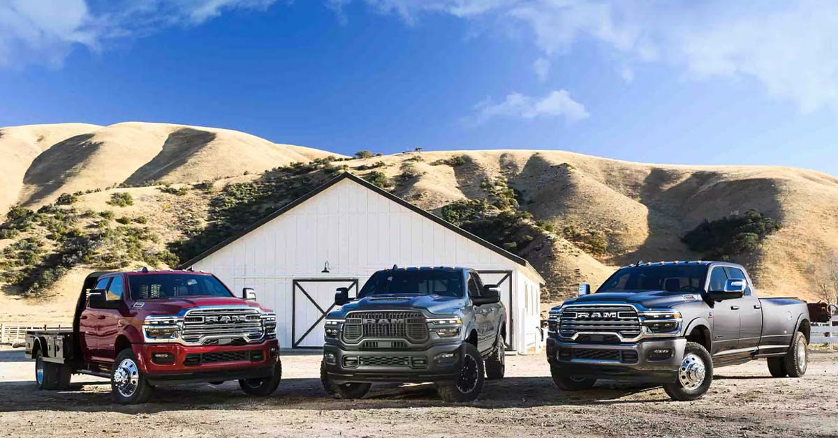 Lineup of 2025 Ram Trucks outside of a ranch.